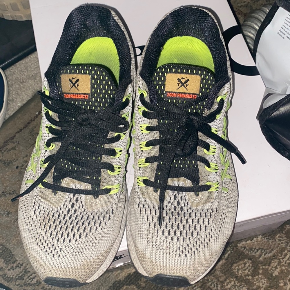 Gray with orange and lime green Nike tennis shoes